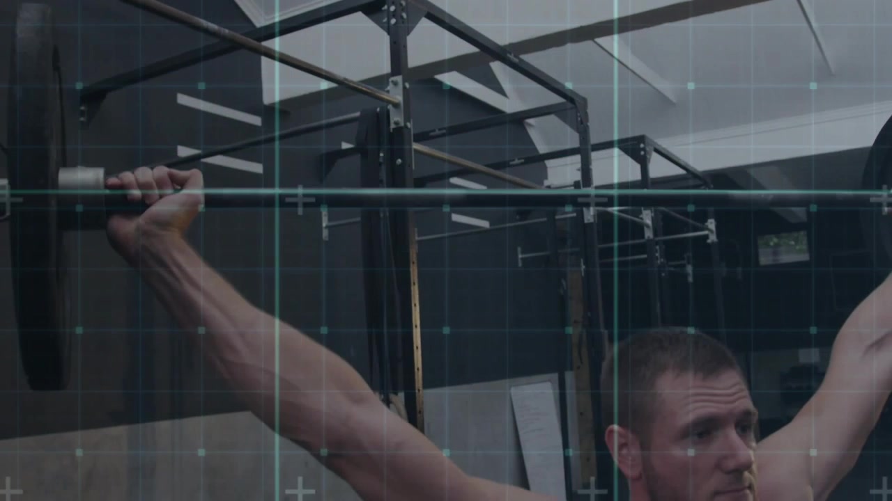 Male athlete starting pull from bent setup lifting bar overhead with grid tracking form for fitness