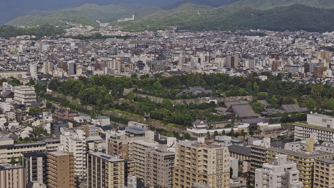 Kyoto Japan Aerial v11 zoomed birds eye view flyover Nakagyo Ward, capturing historic Nijo Castle with lush gardens nestled amidst city's modern landscape - Shot with Mavic 3 Pro Cine - Oct 7th 2023
