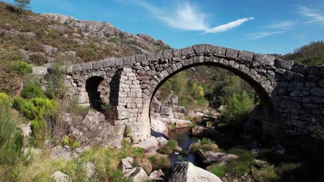 flying over ancient stone bridge over beautiful river