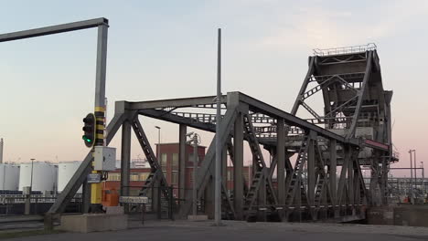 calm-evening-view-of-cars-passing-over-a-bascule-bridge-at-the-port-of-Antwerp,-Boudewijnbrug