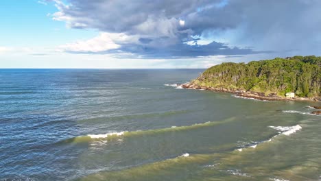 Aerial timelapse of Charlesworth Bay Beach showcasing ocean waves, rocky coastline, and dynamic cloud movement