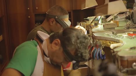 orfebre italiano en el trabajo construyendo un compromiso o un anillo de bodas