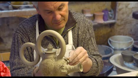 Potter-working-on-clay-sculpture