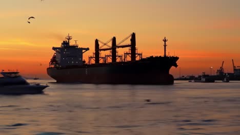 a majestic cargo ship silhouetted against a vibrant sunset, illustrating maritime industry and tranquil waters as day transitions to night