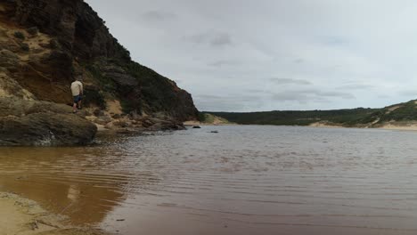 A-fisherman-casts-a-line-in-an-estuary-in-the-great-ocean-road