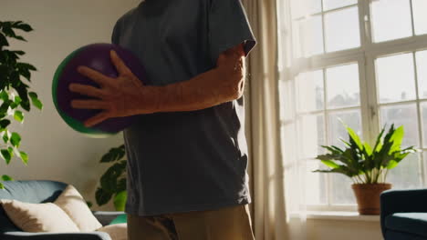 senior man doing physical therapy at home