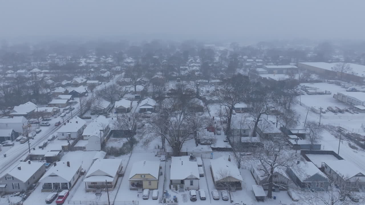 Aerial footage flying over streets and rows of houses in the midst of a snowstorm in Chattanooga, TN.