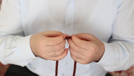 muslim praying with bead for allah