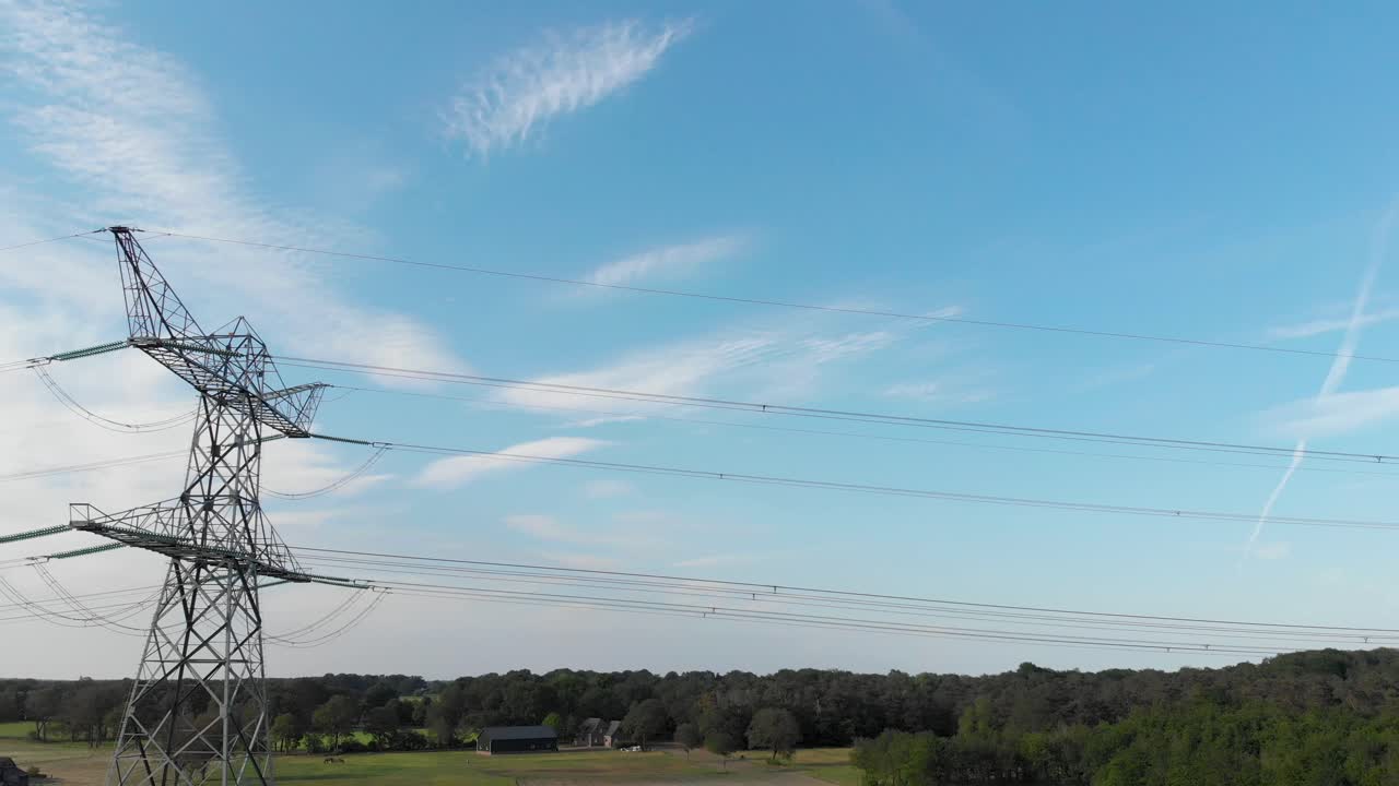 Power lines and transmission tower pylon, blue sky aerial sliding reveal