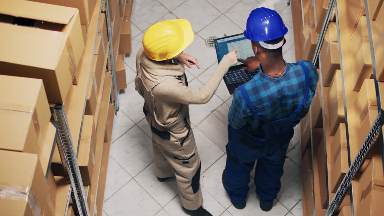 Warehouse Workers Checking Inventory with Laptop