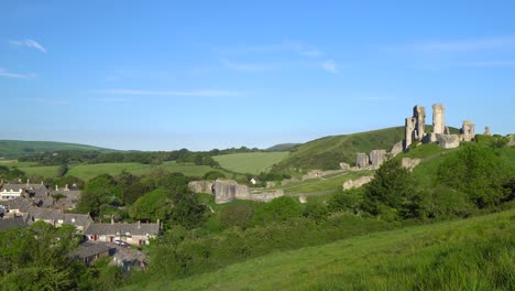 Slow-panning-shot-of-Corfe-village-and-castle-early-morning,-Isle-of-Purbeck,-Dorset,-England