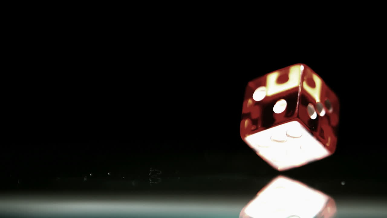 Red dice falling and bouncing close up