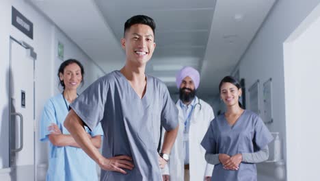 Portrait-of-diverse-doctors-and-nurses-smiling-in-corridor-at-hospital,-in-slow-motion