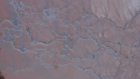 run off water from geothermal hot spring moving along natural terraced mineral layers, top down