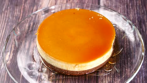 Caramel-custard-pudding-on-a-plate-on-table-,