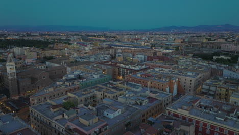 Aerial-ascending-footage-of-blocks-of-apartment-buildings-in-residential-urban-borough-at-dusk.-Rome,-Italy