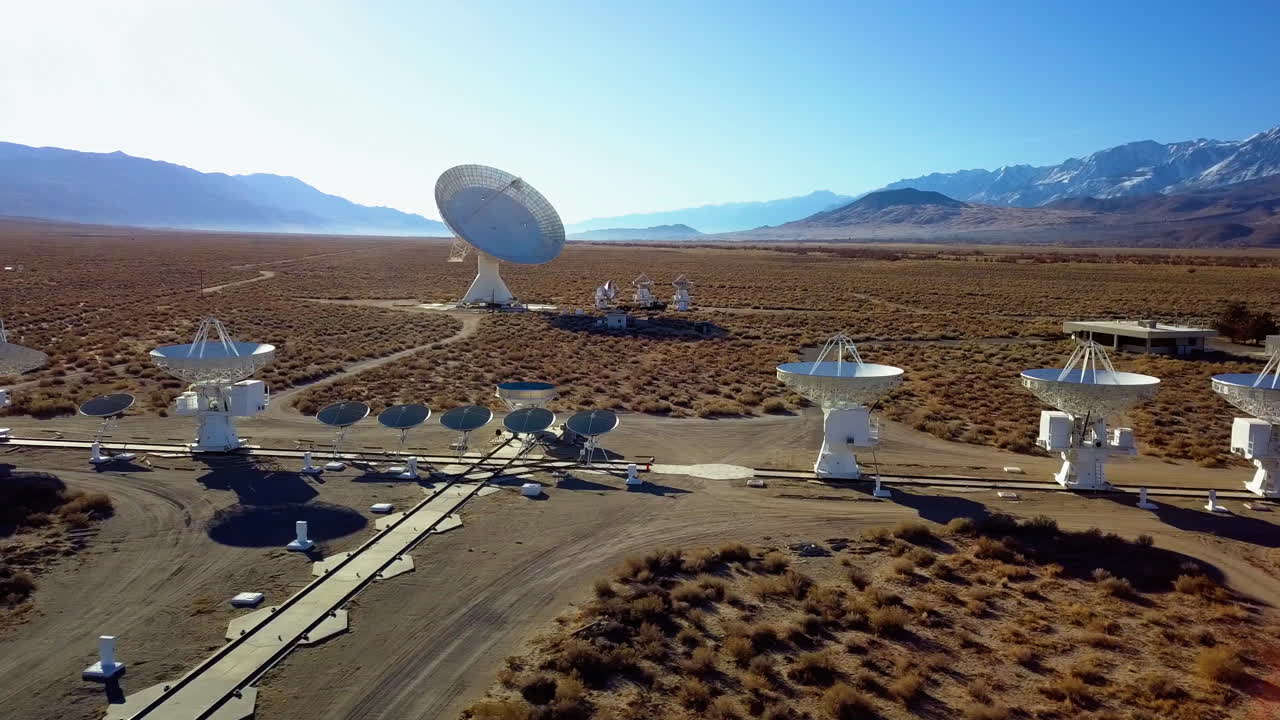 Aerial view of multiple satellite arrays, at a desert in USA - tracking, drone shot