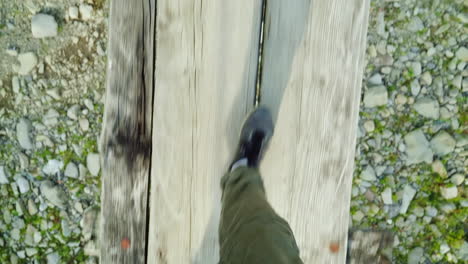 Die-Füße-Eines-Mannes-Gehen-Auf-Einer-Schmalen-Holzbrücke-über-Einen-Bergfluss-Gefahr-Und-Abenteuer
