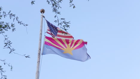 arizona state and usa flag blowing in the wind in slow motion