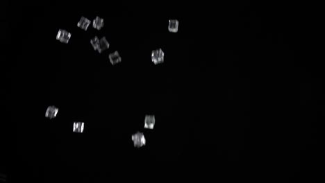 ice cubes launched upwards with a black background