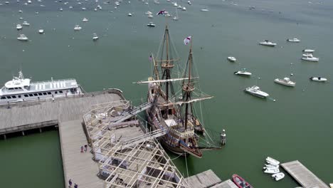 Mayflower-II-is-a-reproduction-of-the-17th-century-ship-docked-at-town-of-Plymouth,-Massachusetts,-USA---orbit,-Aerial