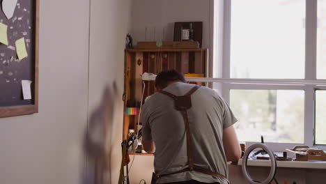 Worker-prepares-light-equipment-to-record-video-in-workshop