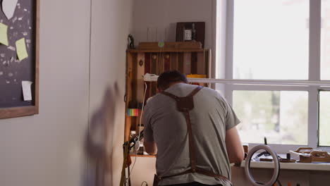 worker prepares light equipment to record video in workshop