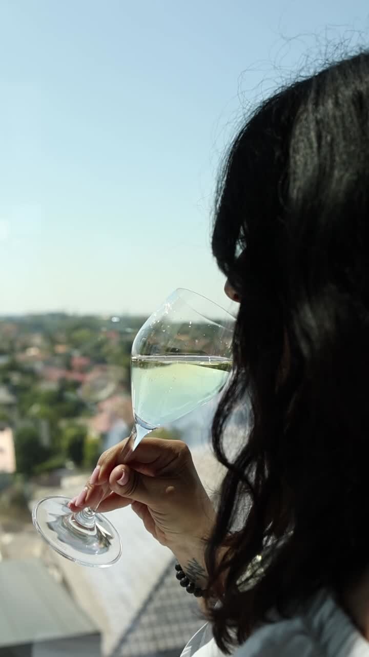 Person holding a glass of wine