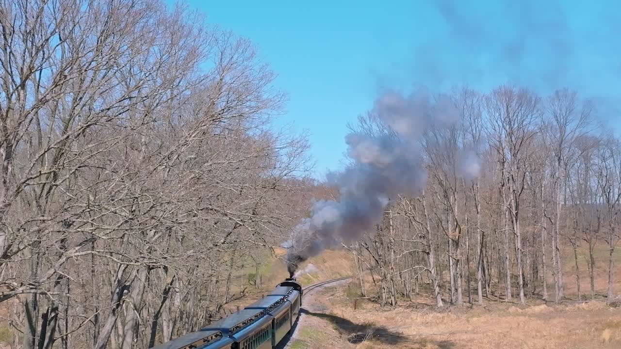 Aerial View of EBT's Narrow Gauge Restored Antique Steam Passenger Train Passing With Steam and Smoke on a Clear Sunny Day