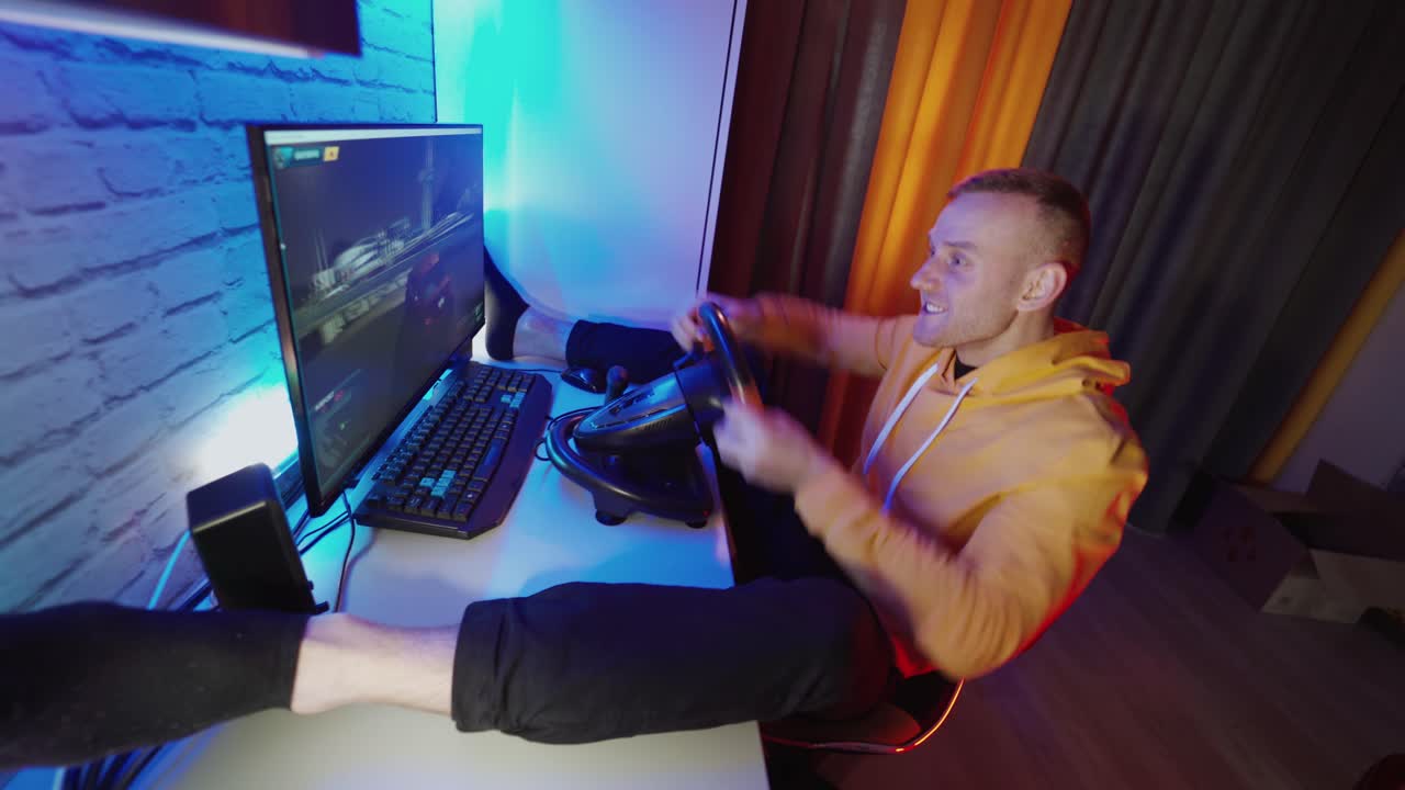 Gamer driving autosimulator. Man gamer hand using black gaming steering wheel joystick and playing in car drive simulator