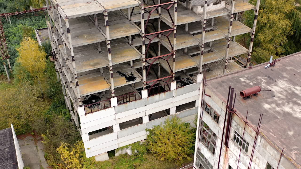 Empty destroyed factory buildings on the background. Aerial view of old abandoned factory.