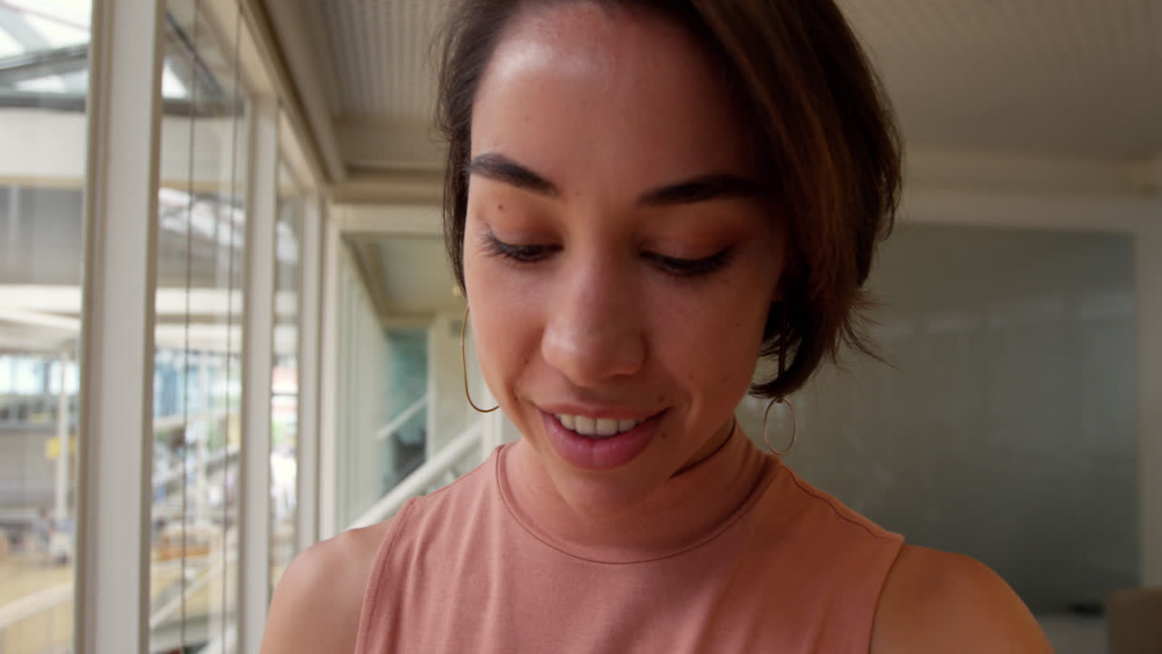 Businesswoman using smartwatch in a modern office 4k