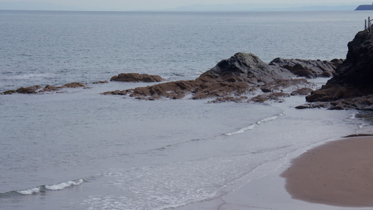Wide shot of exposed rocks at low tide at Aberporth bay