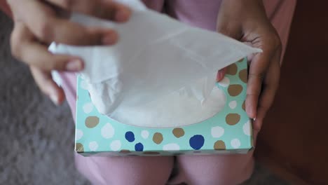 woman holding an open tissue box