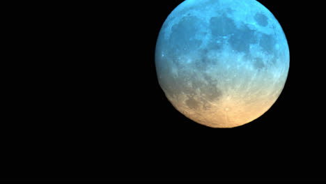 large colourful full moon changing colour phases during astronomical twilight