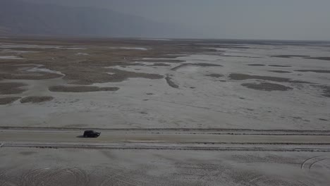 aerial drone shot following vehicle in desert death valley