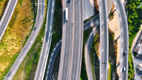 cars weave through european roads. an aerial view of winding roads in europe, with cars navigating the complex network amidst greenery