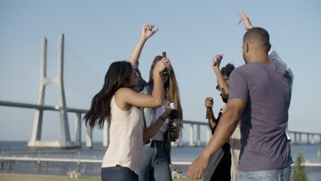 Playful-young-friends-relaxing-together-in-park.