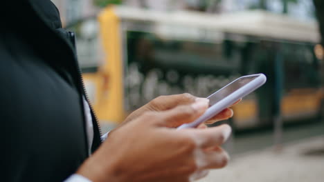 Woman-hands-swiping-smartphone-outdoors-close-up.-Unknown-african-girl-vertical