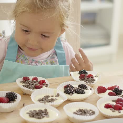 muffin cups being prepared by little girl