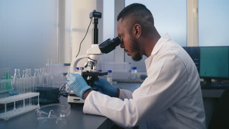 scientist using microscope in a laboratory
