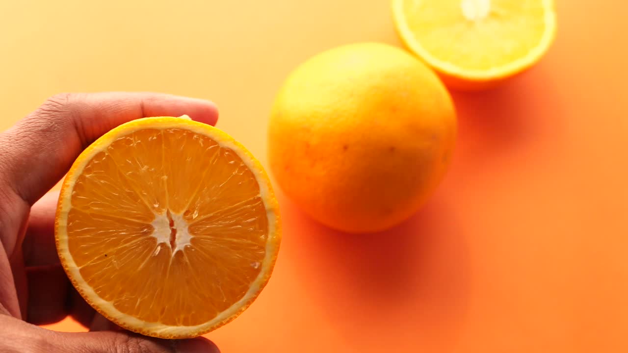 una rebanada de naranja en la mano