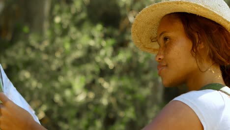 female hiker standing with map in countryside 4k