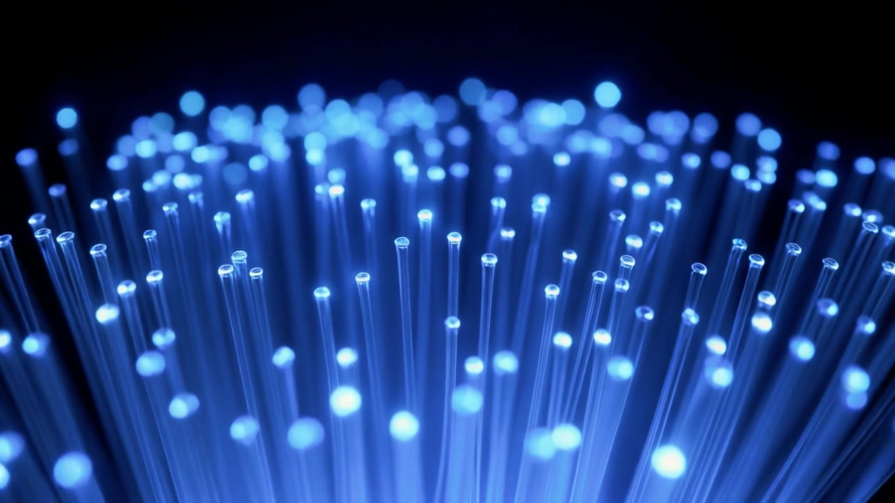 Glowing Blue Fiber Optic Cables Transmitting Data