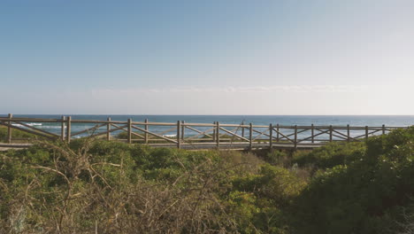 male cyclist on a boardwalk towards the beach