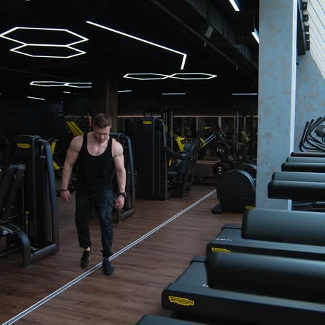 handsome man getting ready for training. man having workout on treadmill in modern gym