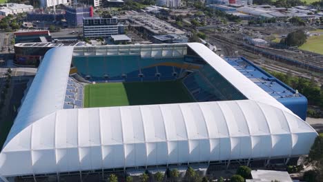 detailed aerial view focusing on the stadium's roof structure and green field.