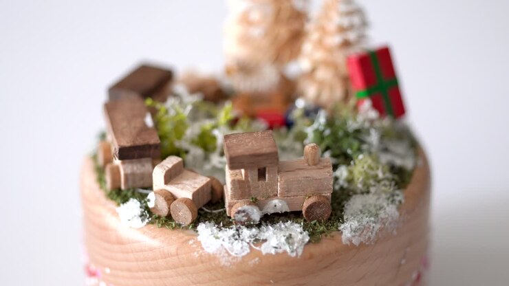 Handmade wooden Christmas music box, scene of train, trees and gifts view, studio white background