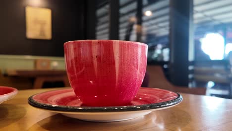 red striped coffee cup on a wooden table