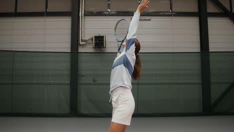 woman playing tennis indoor